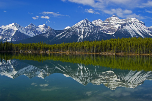 Herbert Lake reflection, peaks surrounding Lake Louise in the background. Icefields Parkway. Banff National Park