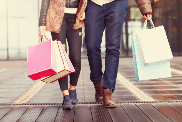 A couple carrying shopping bags