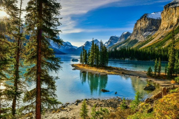 clear blue water is flanked by tall mountains
