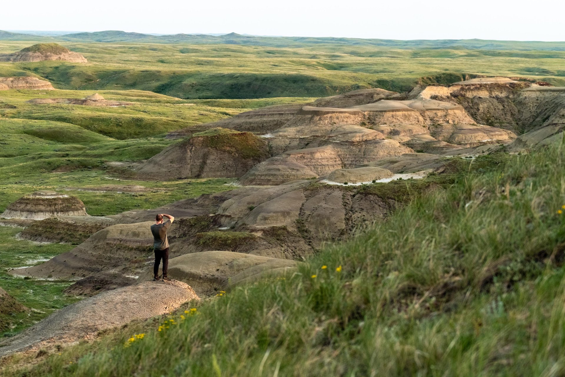A man photographs the Badlands in Saskatchewan's Grasslands National Park