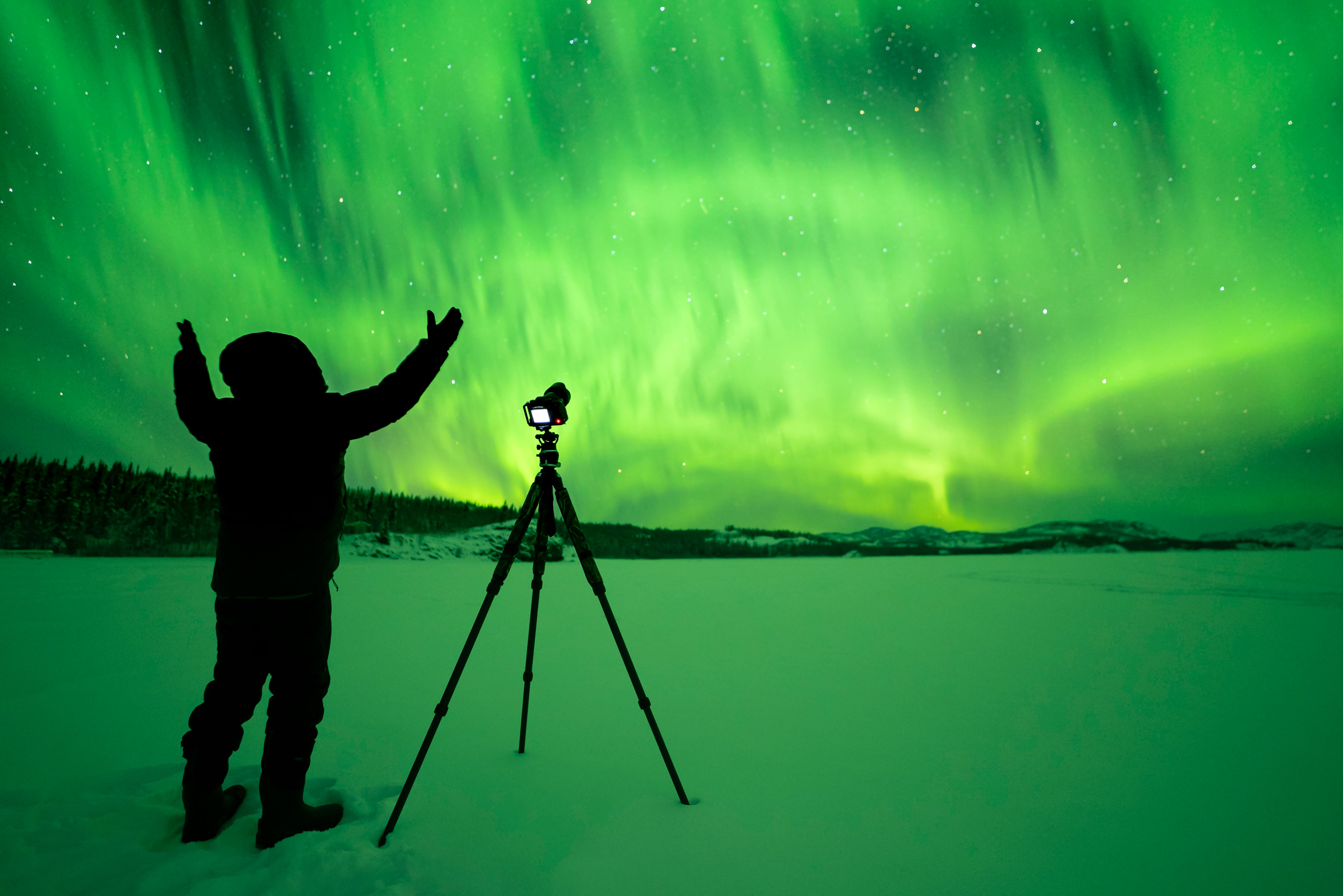 A man takes pictures of the Northern Lights in Yukon