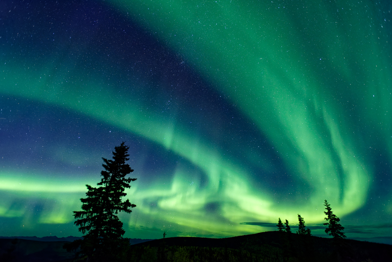 A night sky with northern lights near Dawson City in Yukon