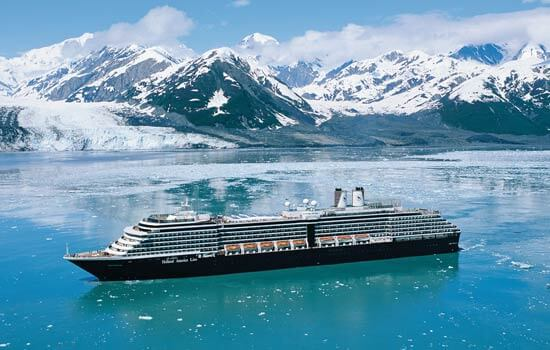 A cruise ship surrounded by snow capped mountains